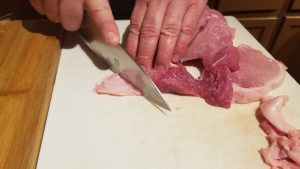 How to make Pork Schnitzel. Cutting all the extra fat off of the pork